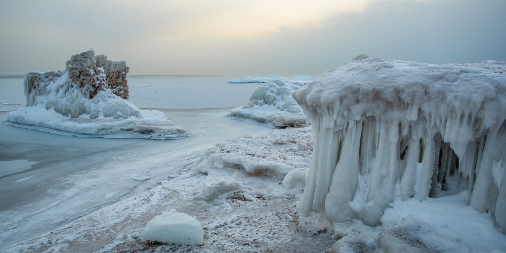 Shoreline ice provides a seasonal break from wave action.
